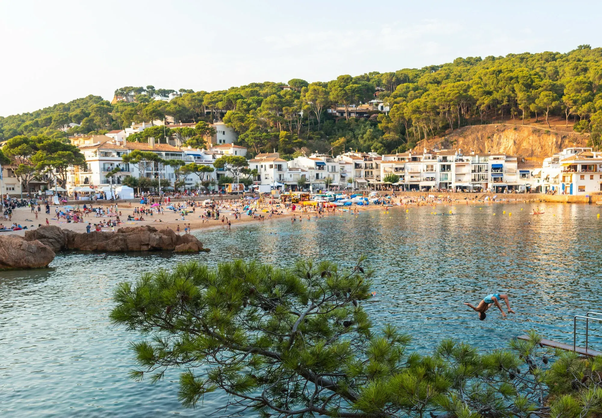 La platja de Tamariu vista des del camí de ronda, amb les cases del poble al fons