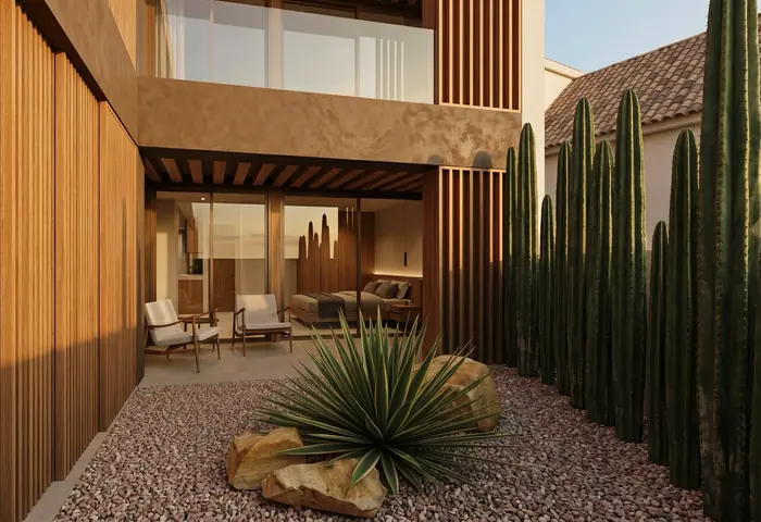 Pati de l'accés amb grava, cactus i el porxo de fusta